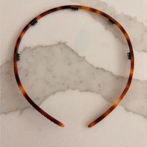 Alexandre de Paris 1/4"-thin headband in a tortoiseshell pattern with sparkles